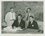Christian Science - Grover Whalen signing contract with Christian Scientists executive committee chairman