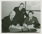 Christian Science - Harvey Gibson signing contract with Christian Scientists executive committee chairman