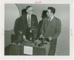 Communications - Exhibits - Men demonstrating film apparatus