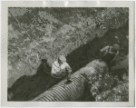 Construction - Men laying sewer pipes