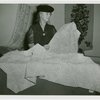 Contests - America through the Needle's Eye - Woman with knitted bedspread