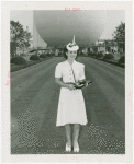 Contests - Beauty - Miss New York World's Fair - Winner in Trylon and Perisphere hat with trophy in front of Perisphere