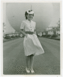 Contests - Beauty - Miss New York World's Fair - Winner in Trylon and Perisphere hat in front of Perisphere