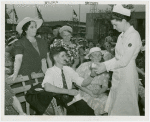 Contests - Crocheting - Nurse applying bandage to contestant