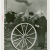 Continental Baking Co. - Man putting seed in reaper while Grover Whalen and M. Lee Marshall (President, Continental Baking Co.) look on