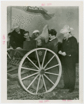 Continental Baking Co. - Man putting seed in reaper while Grover Whalen and M. Lee Marshall (President, Continental Baking Co.) look on