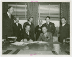 Cosmetics - Grover Whalen and Herman L. Brooks (President, Perfumery and Cosmetic Exhibits) signing contract