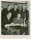 Dominican Republic Participation - Grover Whalen, Charles H. Wanzer (Dominican Chamber of Commerce) and Rafael Leonidas Trujillo Molino (President, Dominican Repubilc) look at contract
