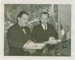Estonian Consul General Charles Kuusik and Grover Whalen sign contract