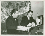 Estonian Consul General Charles Kuusik and Grover Whalen sign contract