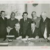 Egypt Participation - Hussein Sabry Pacha (Egyptian High Commissioner) and Grover Whalen sign contract with group looking on