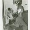 Electric Utilities - Electrified Farm - Woman and two men look at machine