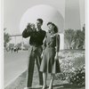 Fairgrounds - Visitors - Man and woman in front of Trylon and Perisphere take photograph