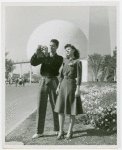 Fairgrounds - Visitors - Man and woman in front of Trylon and Perisphere take photograph