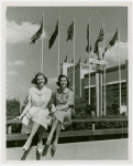 Fairgrounds - Visitors - Two women sitting on handrail of bridge