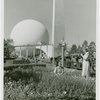 Fairgrounds - Visitors - Two women taking photographs in grass in front of Trylon and Perisphere