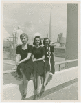 Fairgrounds - Visitors - Three women sitting on handrail of bridge