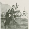 Fairgrounds - Visitors - Women pose on rock wall with scene in background