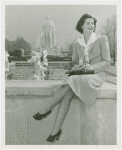Fairgrounds - Visitors - Woman sits on wall with George Washington statue in background