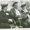 Fairgrounds - Visitors - Women and man on bench look at guidebook