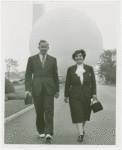 Fairgrounds - Visitors - Man and woman walking in front of Trylon and Perisphere