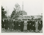 Fairgrounds - Visitors - Group of women with Trylon and Perisphere construction in background