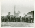 Fairgrounds - Visitors - Group of men with Trylon and Perisphere under construction in background