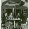 Fashion, World of - Models - Models for Uptown Guild having drinks under umbrella