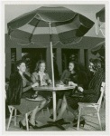Fashion, World of - Models - Models for Uptown Guild having drinks under umbrella