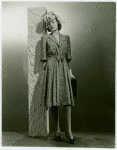 Fashion, World of - Models - Dresses - Model leaning against pole