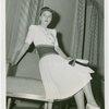 Fashion, World of - Models - Dresses - Model poses on chair