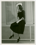 Fashion, World of - Models - Dresses - Model poses by window