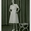 Fashion, World of - Models - Dresses - Model poses by stool