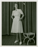 Fashion, World of - Models - Dresses - Model poses by stool