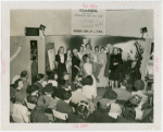 Fashion, World of - Models - Hairstyles - Model wrapped in cellophane in front of crowd