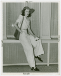 Fashion, World of - Models - Suits - Model sitting in front of window