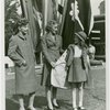 Fashion, World of - Models - Suits - Mother and daughter models posing in front of flags