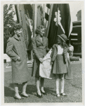 Fashion, World of - Models - Suits - Mother and daughter models posing in front of flags