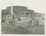 Federal Housing Administration - Houses - Construction - Men building house in front of Contemporary Art Building