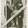 Federal Housing Administration - Houses - Construction - Group looks at plans in front of house