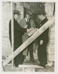 Federal Housing Administration - Houses - Construction - Group looks at plans in front of house