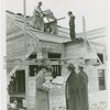 Federal Housing Administration - Houses - Construction - Men building house while group looks on