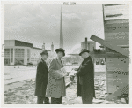 Federal Housing Administration - Houses - Construction - Group looks at paper at construction site