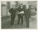Federal Housing Administration - Houses - Construction - Group looks at plan at construction site
