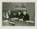 Finland Participation - Harry Roneholm (Finland Commissioner), K.F. Altio and William Standley sign contract