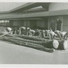 Firestone - Men with oil palm logs