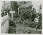 Firestone - Building - Farm - Boy watching woman plant flowers