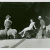 Firestone - Building - Farm - Man pushing woman in wheelbarrow and man with sheep