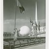 Flags - Woman under flag with Trylon and Perisphere in background