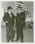 Flags - Two men in front of American flag